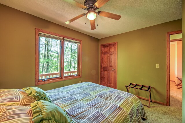 27166 Hersant Rd, Meenon Twp, WI 54893 - carpeted bedroom with baseboards, a textured ceiling, and ceiling fan
