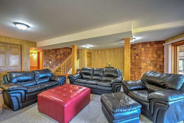 27166 Hersant Rd, Meenon Twp, WI 54893 - living area with wood walls, carpet flooring, and stairway