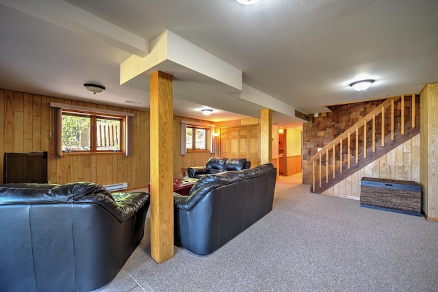 27166 Hersant Rd, Meenon Twp, WI 54893 - carpeted living room with wood walls, stairway, healthy amount of natural light, and baseboard heating