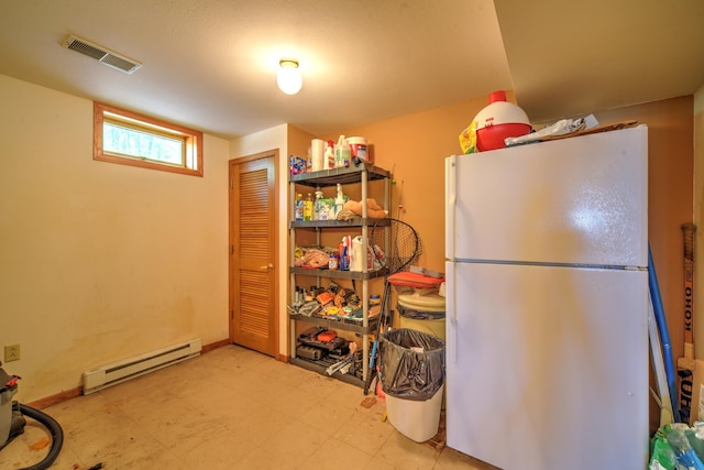 27166 Hersant Rd, Meenon Twp, WI 54893 - kitchen with freestanding refrigerator, a baseboard radiator, tile patterned floors, and baseboards