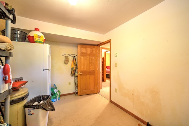 27166 Hersant Rd, Meenon Twp, WI 54893 - kitchen with baseboards, light floors, and freestanding refrigerator