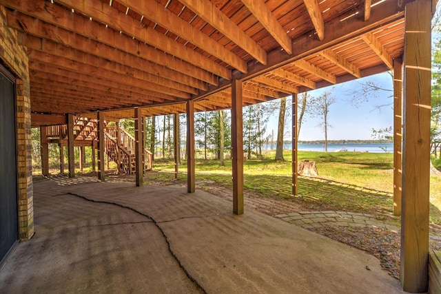 27166 Hersant Rd, Meenon Twp, WI 54893 - view of patio featuring stairs, a water view, a carport, and a pergola