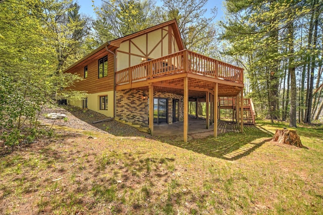 27166 Hersant Rd, Meenon Twp, WI 54893 - back of property featuring a deck, a lawn, stairs, a patio, and stucco siding