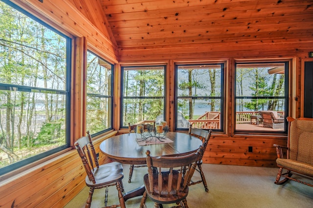 27166 Hersant Rd, Meenon Twp, WI 54893 - sunroom featuring vaulted ceiling, plenty of natural light, wooden walls, and carpet floors