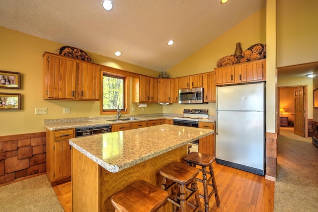 27166 Hersant Rd, Meenon Twp, WI 54893 - kitchen featuring freestanding refrigerator, stainless steel microwave, a sink, dishwasher, and vaulted ceiling
