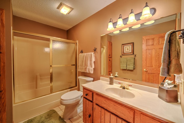27166 Hersant Rd, Meenon Twp, WI 54893 - bathroom with vanity, toilet, a textured ceiling, combined bath / shower with glass door, and tile patterned flooring