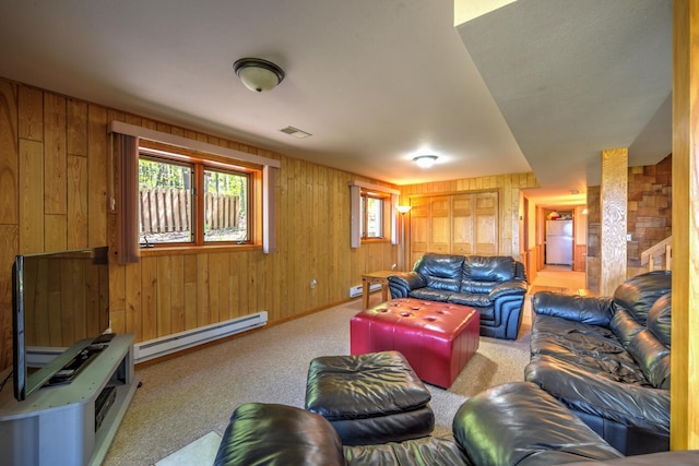 27166 Hersant Rd, Meenon Twp, WI 54893 - living room with baseboard heating, wood walls, carpet floors, and a baseboard heating unit