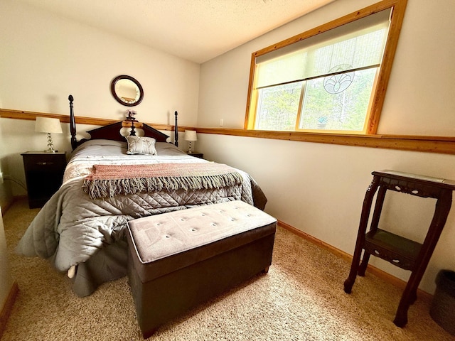 bedroom with carpet floors and baseboards