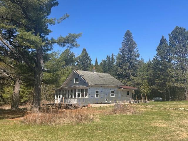 5535 Wahlsten Rd, Embarrass, MN 55732 - rear view of house featuring a lawn