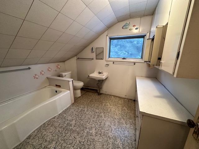 5535 Wahlsten Rd, Embarrass, MN 55732 - bathroom featuring toilet, vaulted ceiling, a tub to relax in, and vanity