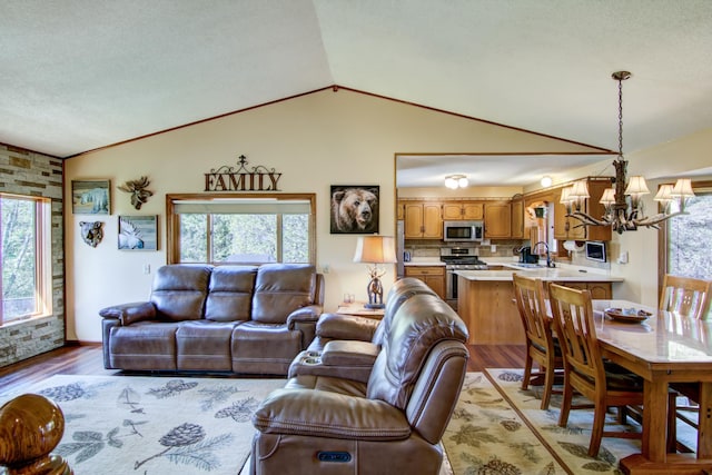14177 205th St N, Scandia, MN 55073 - living room featuring a chandelier, lofted ceiling, and light wood-style floors