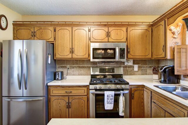 14177 205th St N, Scandia, MN 55073 - kitchen with stainless steel appliances, brown cabinets, light countertops, and a textured ceiling