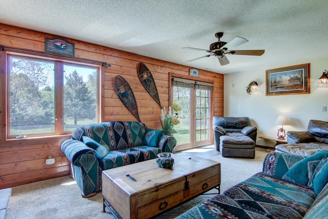 14177 205th St N, Scandia, MN 55073 - carpeted living area with a textured ceiling, a ceiling fan, and wooden walls