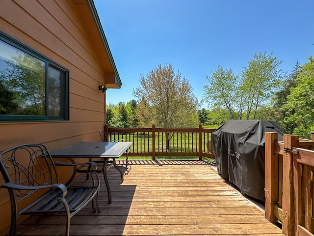 14177 205th St N, Scandia, MN 55073 - wooden terrace featuring outdoor dining area, view of scattered trees, and area for grilling