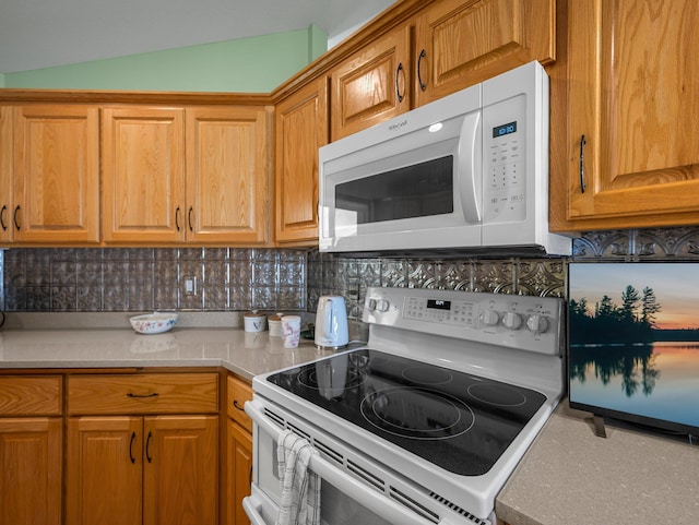 2200 142nd Ln NW, Andover, MN 55304 - kitchen featuring white appliances, decorative backsplash, light countertops, brown cabinets, and lofted ceiling