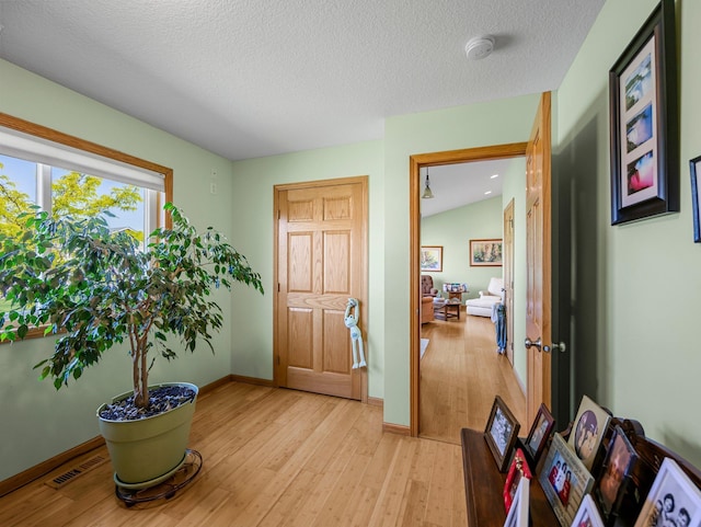 2200 142nd Ln NW, Andover, MN 55304 - foyer with light wood-style floors, baseboards, and a textured ceiling