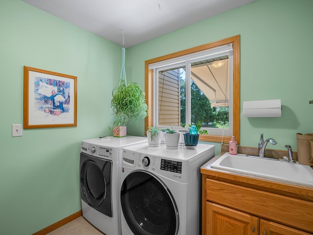 2200 142nd Ln NW, Andover, MN 55304 - washroom featuring washing machine and clothes dryer, cabinet space, light tile patterned flooring, and baseboards