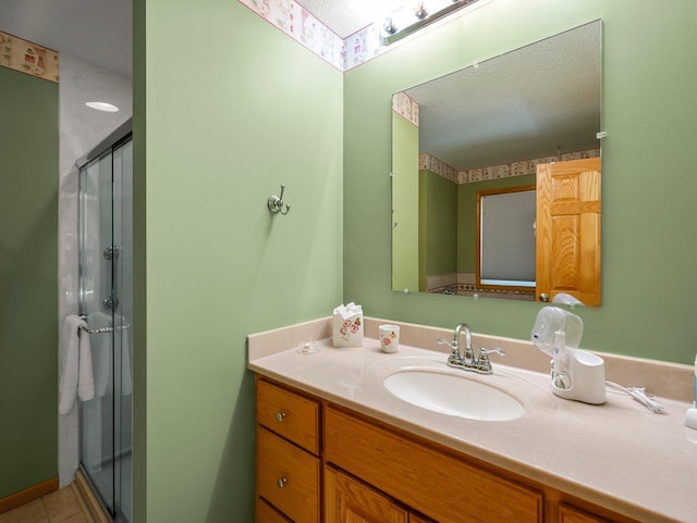 2200 142nd Ln NW, Andover, MN 55304 - bathroom with vanity, a shower stall, a textured ceiling, and tile patterned flooring