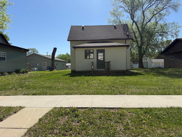 408 Jefferson St, Minneota, MN 56264 - rear view of house with a lawn and a shingled roof