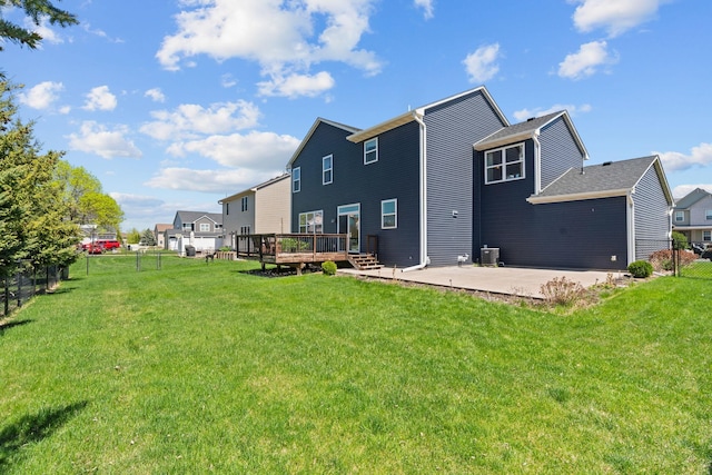 rear view of property featuring a deck, a patio area, and a residential view