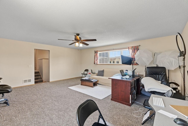 office area with a ceiling fan, a textured ceiling, and carpet flooring