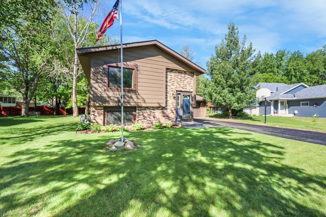 805 3rd Ave N, Sartell, MN 56377 - view of front facade featuring brick siding and a front yard