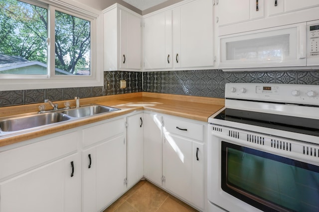805 3rd Ave N, Sartell, MN 56377 - kitchen with white appliances, light countertops, light tile patterned flooring, a sink, and decorative backsplash