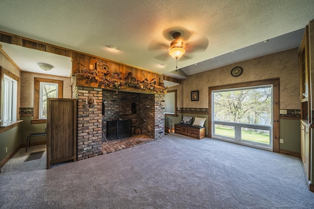 28571 Buffalo Lake Rd, Richwood Twp, MN 56521 - unfurnished living room featuring a textured ceiling, ceiling fan, carpet flooring, plenty of natural light, and a fireplace