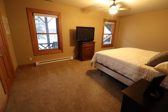 28571 Buffalo Lake Rd, Richwood Twp, MN 56521 - carpeted bedroom featuring a baseboard radiator, multiple windows, baseboards, and a ceiling fan