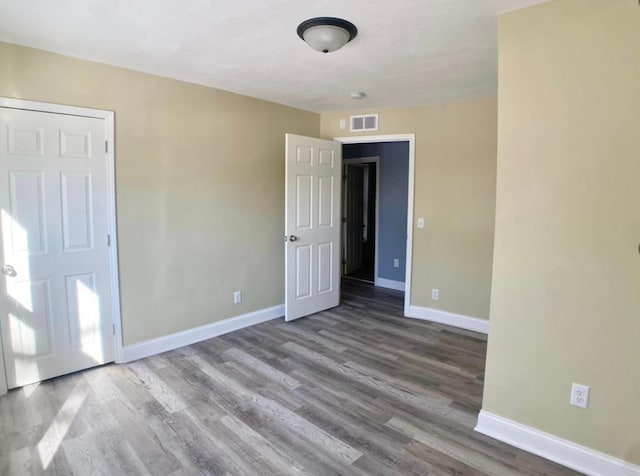 unfurnished bedroom with baseboards and wood finished floors