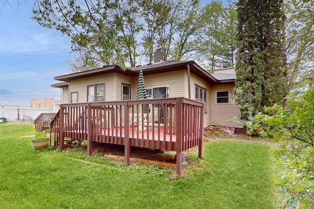 235 2nd Ave N, Isle, MN 56342 - back of property featuring a deck, a chimney, and a yard
