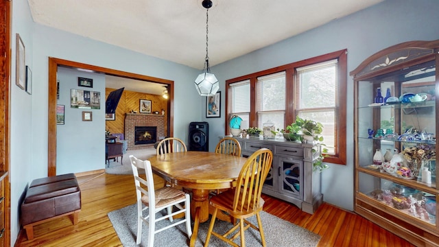 235 2nd Ave N, Isle, MN 56342 - dining room with a fireplace and wood finished floors