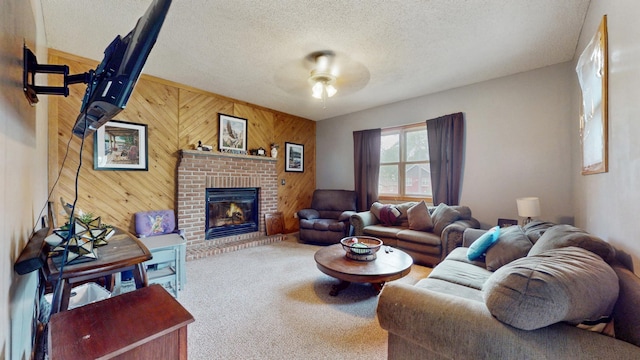 235 2nd Ave N, Isle, MN 56342 - living area with wooden walls, a fireplace, a ceiling fan, carpet, and a textured ceiling