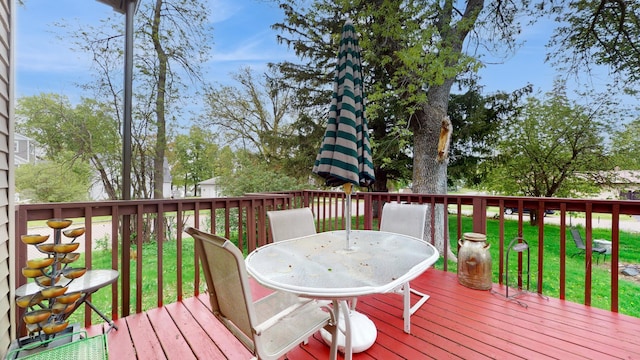 235 2nd Ave N, Isle, MN 56342 - wooden deck featuring outdoor dining space and a lawn