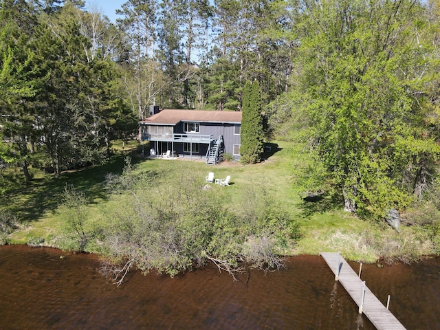 10415 Sorenson Dr, Hayward, WI 54843 - rear view of house with a deck with water view, stairway, a yard, and a chimney