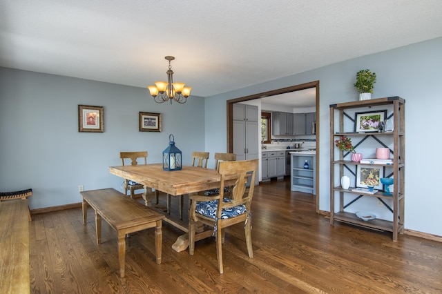 10415 Sorenson Dr, Hayward, WI 54843 - dining area featuring a chandelier, dark wood finished floors, and baseboards