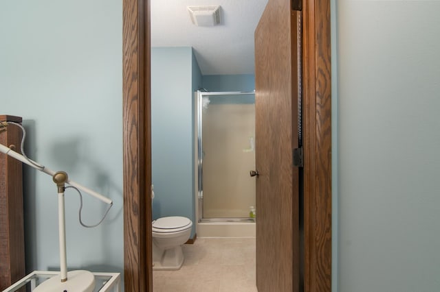 10415 Sorenson Dr, Hayward, WI 54843 - bathroom featuring a stall shower, toilet, a textured ceiling, and tile patterned flooring