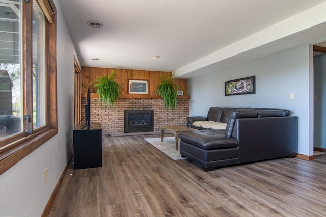 10415 Sorenson Dr, Hayward, WI 54843 - living room featuring wood finished floors, baseboards, a fireplace, and wooden walls