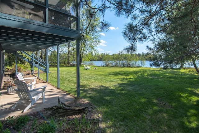 10415 Sorenson Dr, Hayward, WI 54843 - view of grassy yard featuring a water view, stairs, and a patio