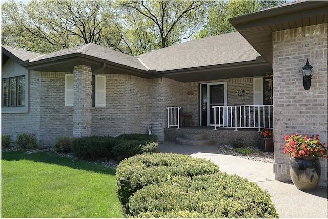 514 10th St N, Sartell, MN 56377 - entrance to property with brick siding, roof with shingles, covered porch, and a lawn