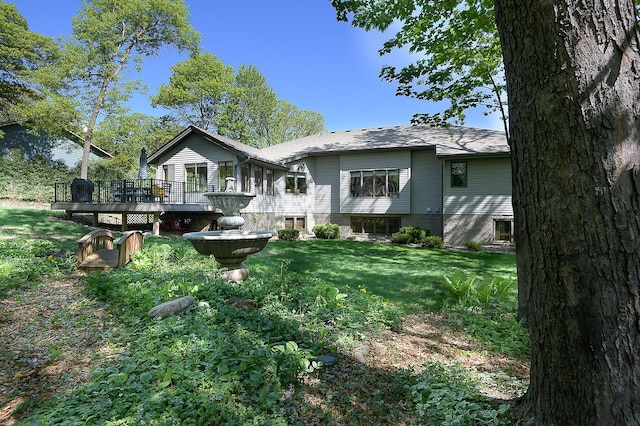 514 10th St N, Sartell, MN 56377 - rear view of property with a yard and a wooden deck