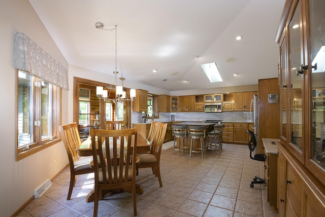 514 10th St N, Sartell, MN 56377 - dining area with vaulted ceiling, baseboards, and a skylight