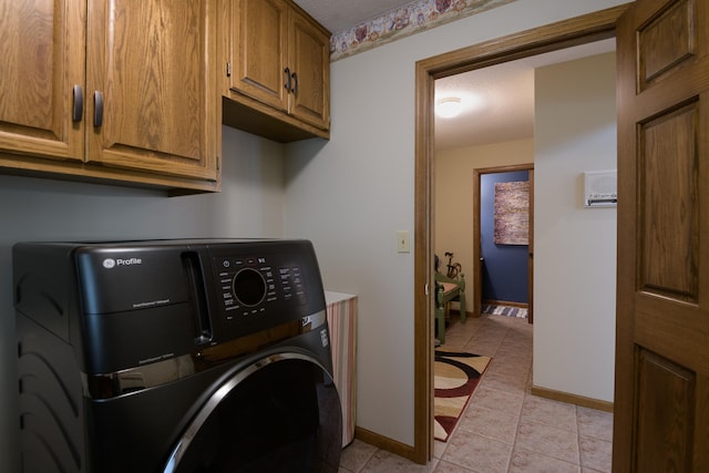 514 10th St N, Sartell, MN 56377 - washroom featuring washer / dryer, cabinet space, baseboards, a textured ceiling, and light tile patterned floors