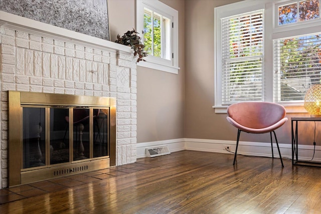 4505 47th Ave S, Minneapolis, MN 55406 - living area featuring a brick fireplace, wood finished floors, and baseboards