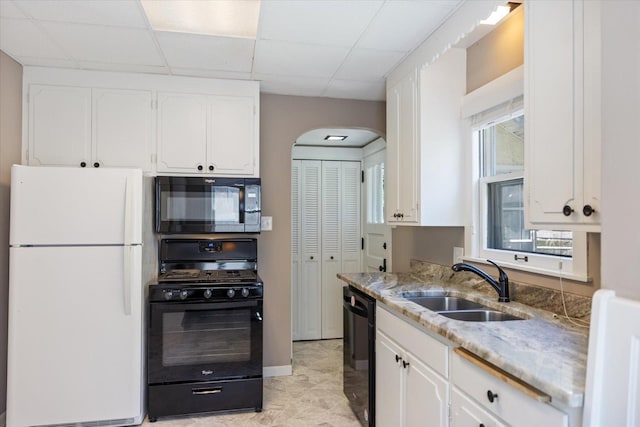 4505 47th Ave S, Minneapolis, MN 55406 - kitchen featuring black appliances, a sink, white cabinetry, light stone countertops, and a paneled ceiling