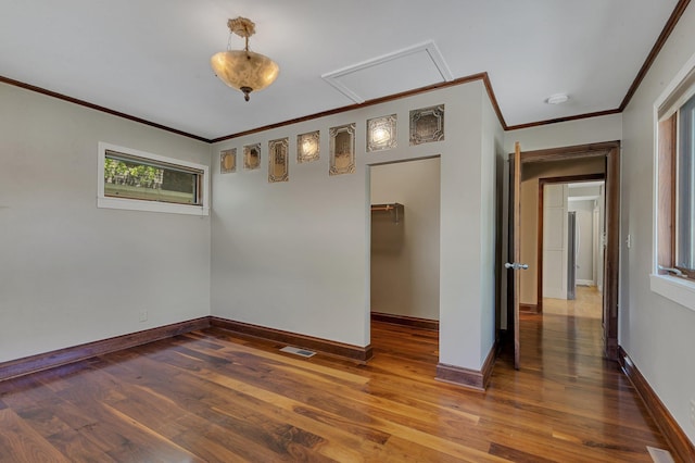 506 Riverside Dr SE, Saint Cloud, MN 56304 - unfurnished room with healthy amount of natural light, ornamental molding, wood finished floors, baseboards, and a smoke detector