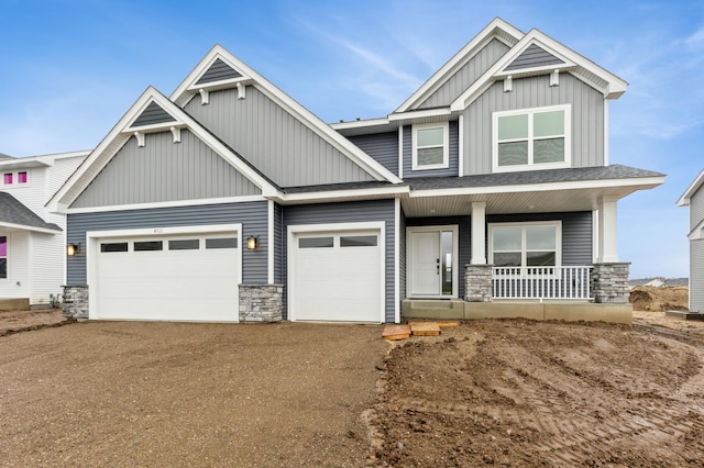 4021 Heath Ln N, Oakdale, MN 55128 - craftsman-style house with a porch, board and batten siding, stone siding, driveway, and a garage