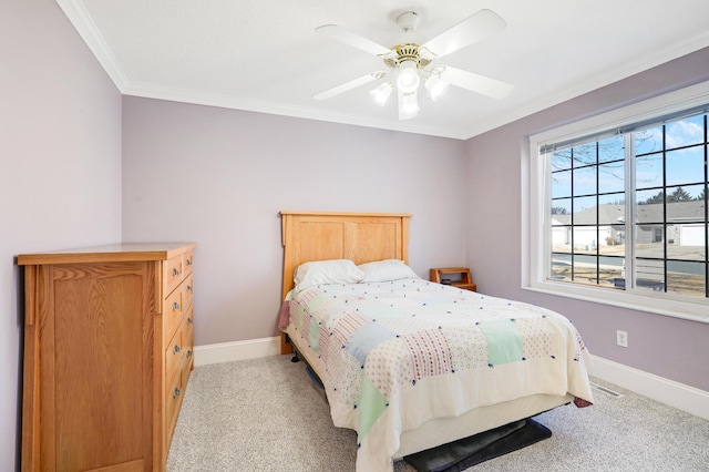 bedroom with carpet floors, ornamental molding, baseboards, and a ceiling fan
