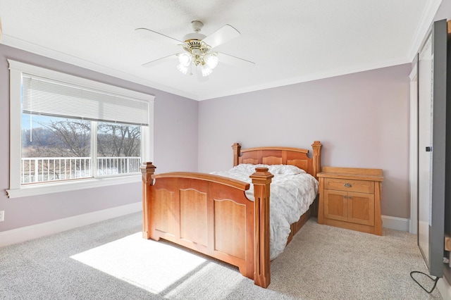 bedroom with light carpet, crown molding, baseboards, and ceiling fan