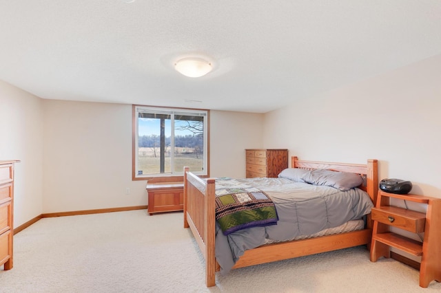 bedroom with light carpet and baseboards
